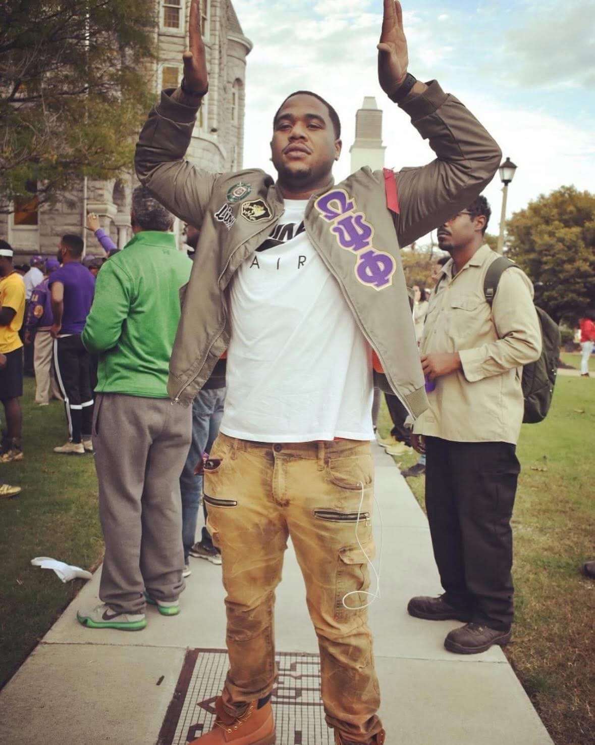 JT showing Omega Psi Phi pride on campus
